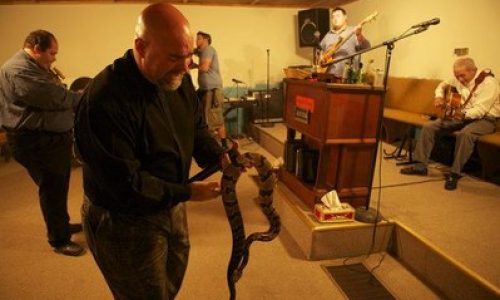 Pastor Jamie Coots in a snake handling service at his church